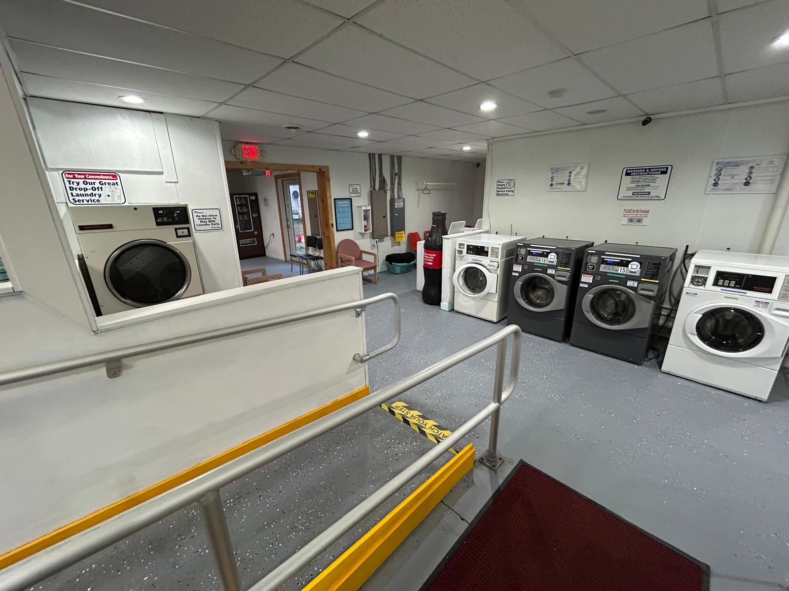 The drop-off area inside Bayside Coin Laundry where dry cleaning and wash-and-fold orders are received